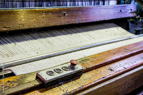 Close up of a cotton thread weft loom machine in a conveyor belt factory