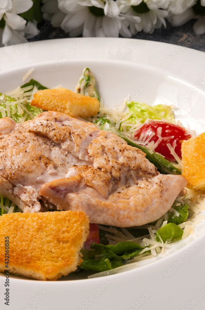 Caesar salad on a white plate. Vertical frame Caesar salad on a white plate. Vertical frame