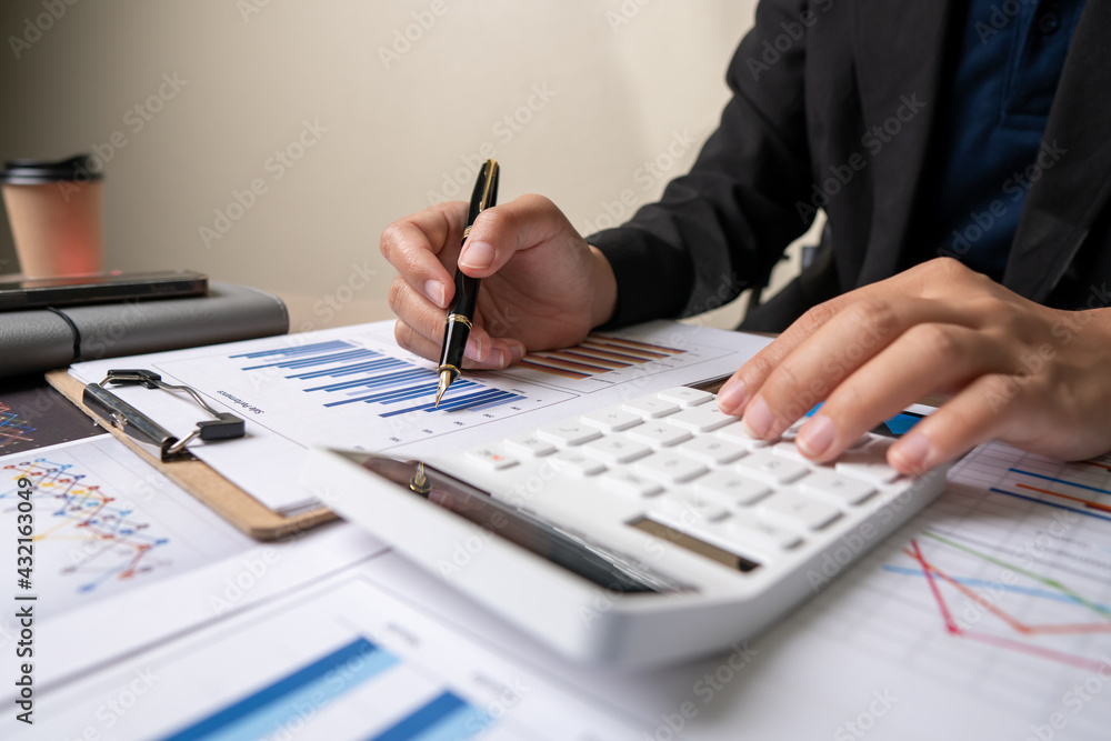 Fototapeta premium bookkeeper or financial inspector hands making report, calculating or checking balance. Home finances, investment, economy, saving money or insurance concept