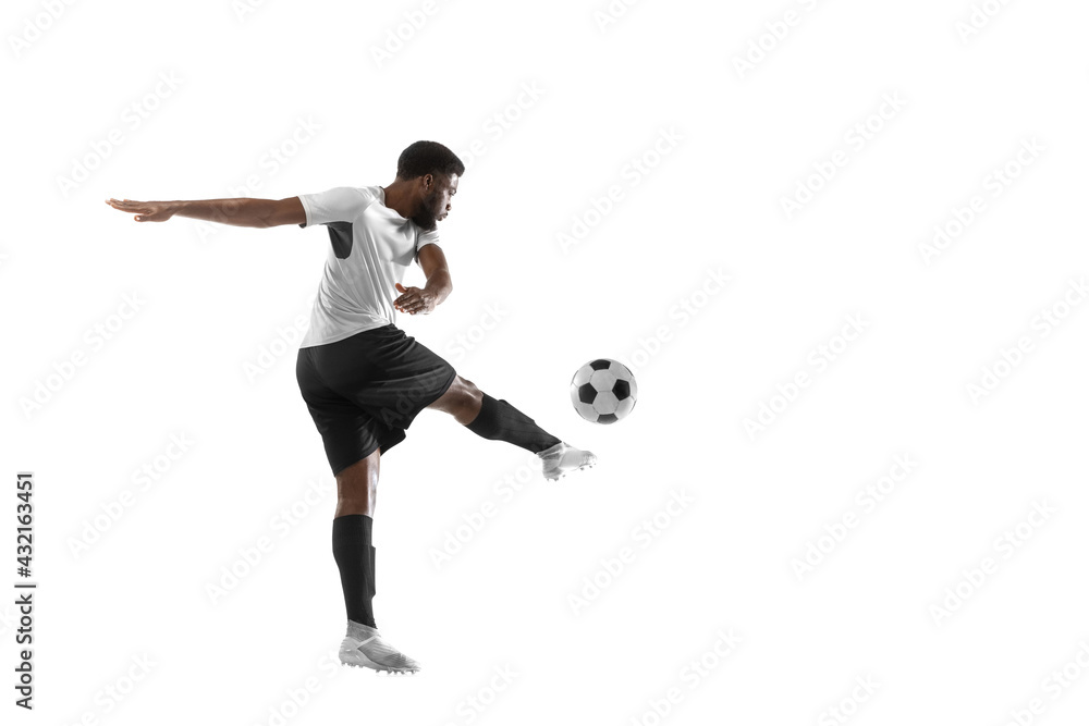 Young African football soccer player training isolated on white background. Concept of sport, movement, energy and dynamic.