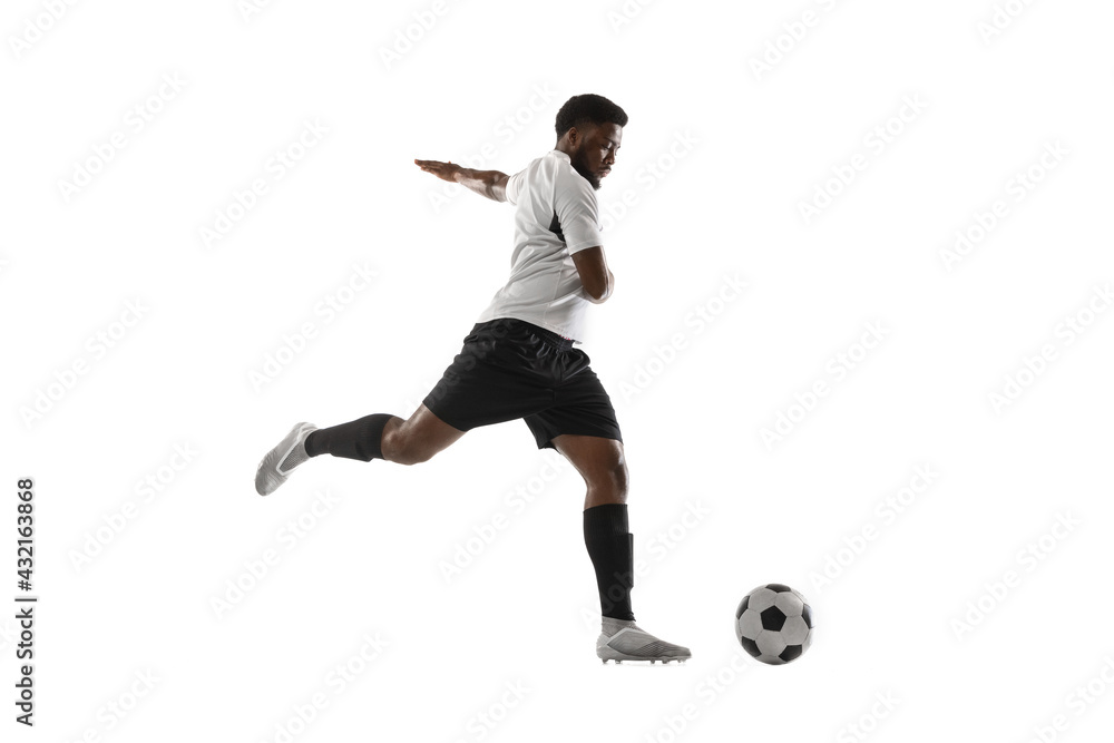 Fototapeta premium Young African football soccer player training isolated on white background. Concept of sport, movement, energy and dynamic.