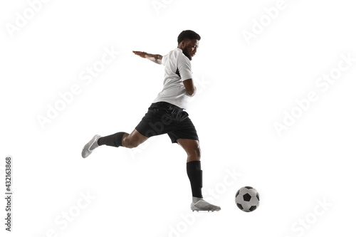 Young African football soccer player training isolated on white background. Concept of sport, movement, energy and dynamic. © master1305