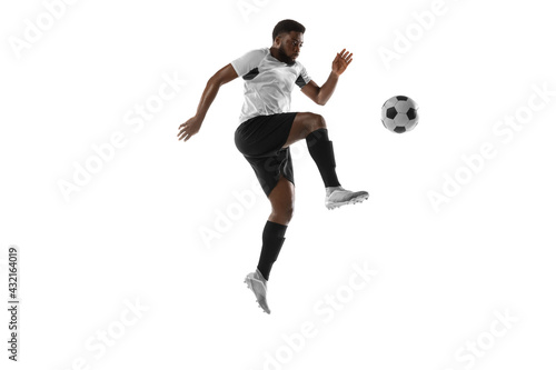 Young African football soccer player training isolated on white background. Concept of sport, movement, energy and dynamic. © master1305