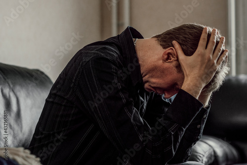 Man holding head in hands photo