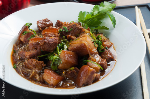 Asian cuisine: pork with glass noodles and soy sauce