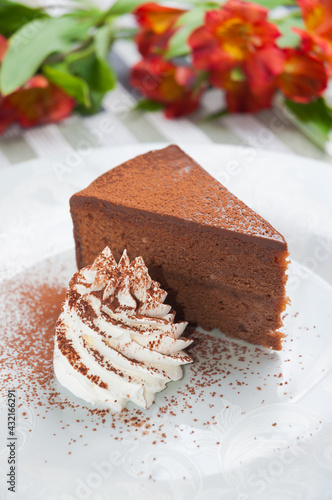 Sacher cake with whipped cream. Vertical frame