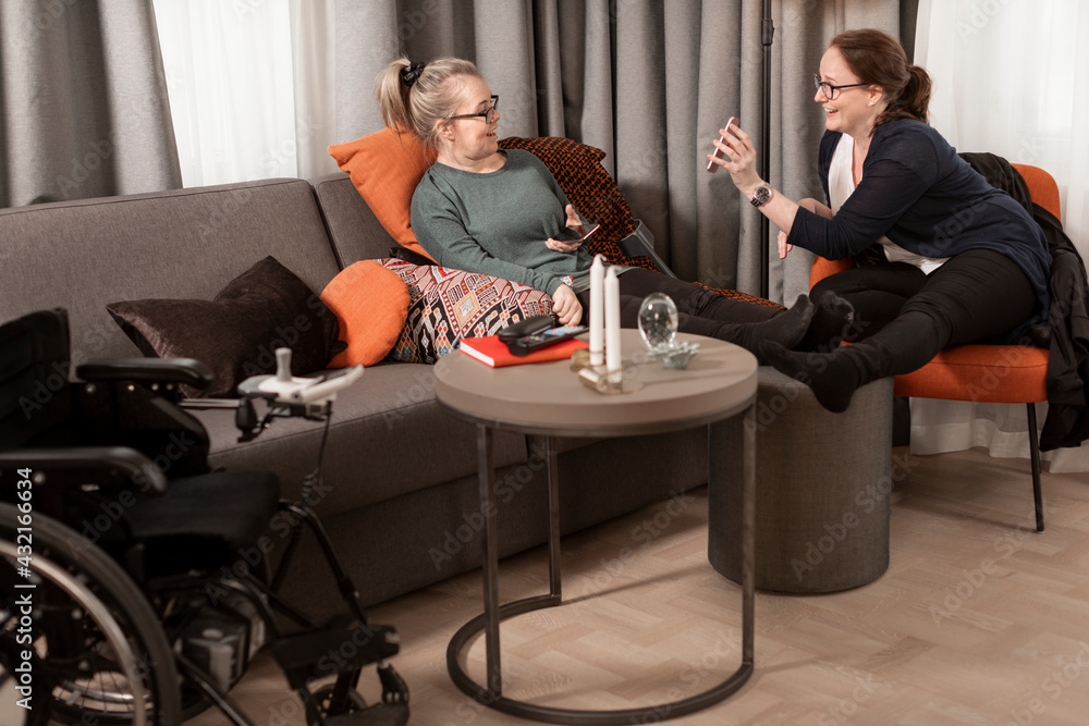 Female friends sitting in living room Female friends sitting in living room
