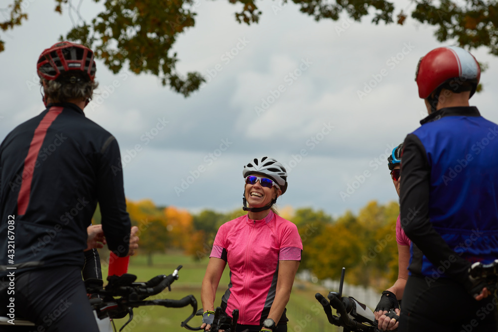 Smiling cyclists talking together Smiling cyclists talking together