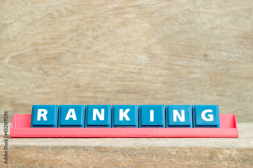 Tile alphabet letter with word ranking in red color rack on wood background © bankrx