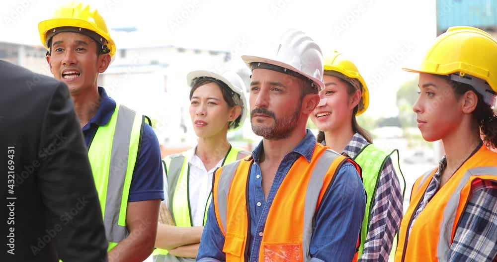 Business man manager or Foreman Speaker giving a talk on corporate Business morning meeting at container yard. Unity and teamwork concept. Audience at the morning brief Business man manager or Foreman Speaker giving a talk on corporate Business morning meeting at container yard. Unity and teamwork concept. Audience at the morning brief