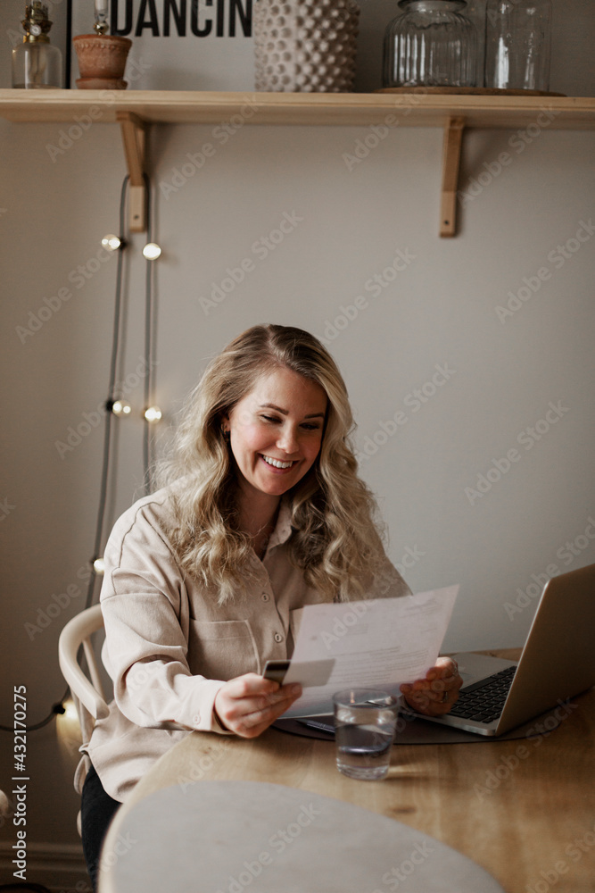 Woman reading documents at home