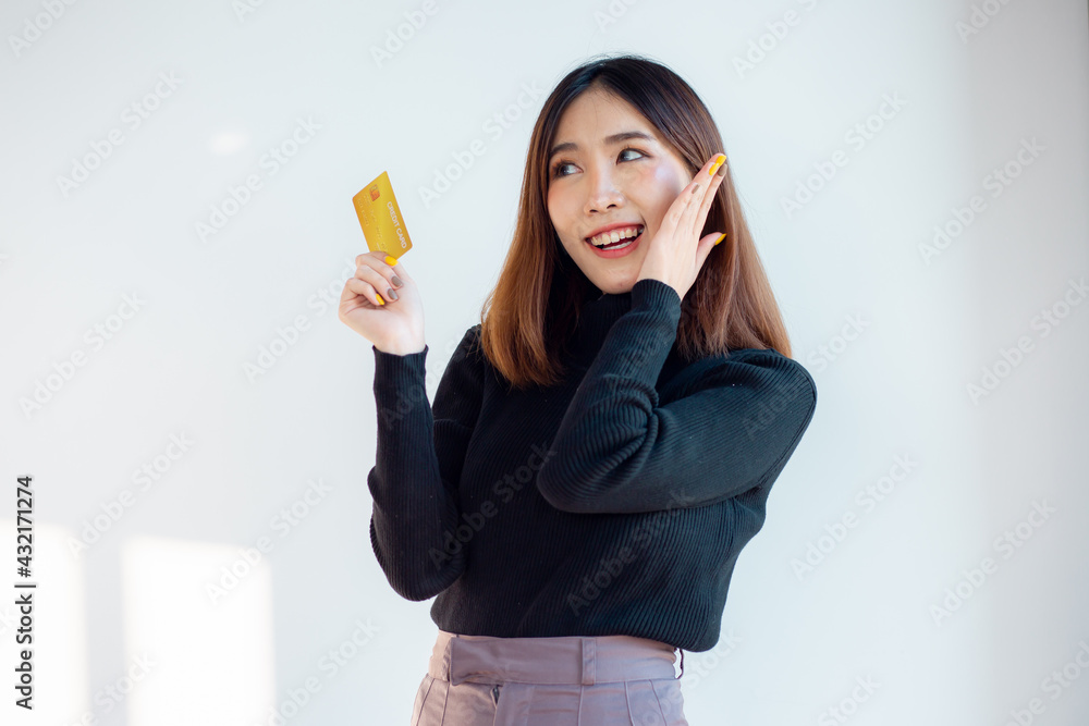Portrait of charming asian young woman ready to pay with credit card on an online store, isolated over white background Portrait of charming asian young woman ready to pay with credit card on an online store, isolated over white background