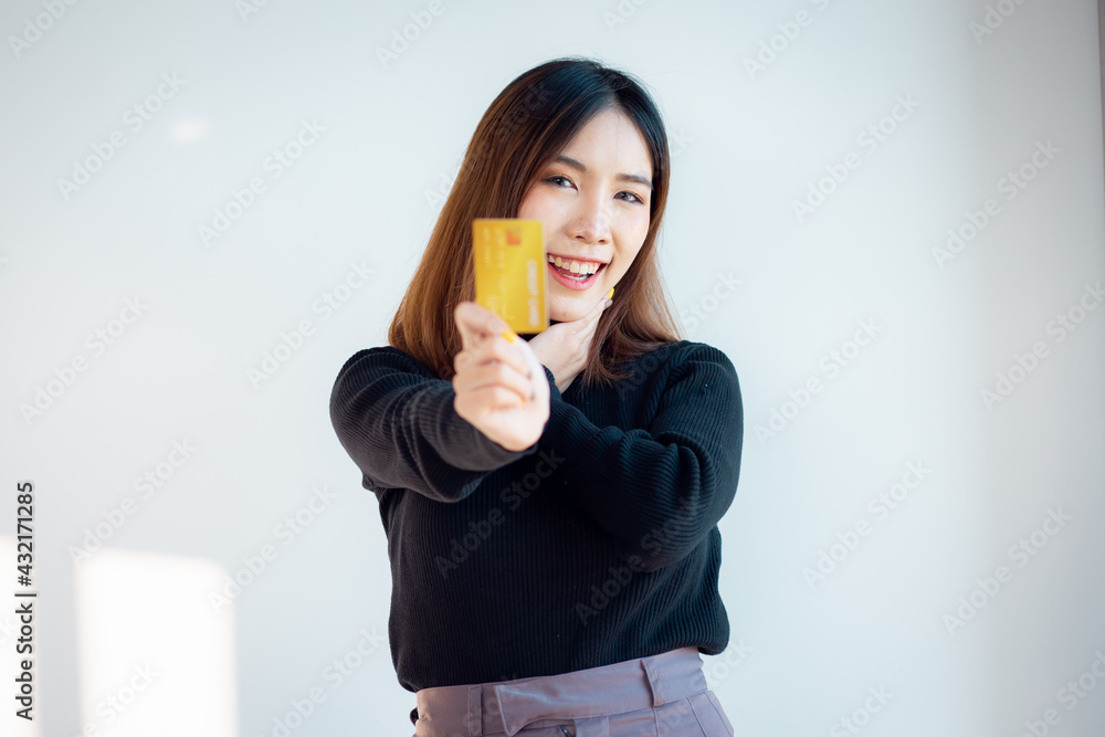 Portrait of charming asian young woman ready to pay with credit card on an online store, isolated over white background Portrait of charming asian young woman ready to pay with credit card on an online store, isolated over white background