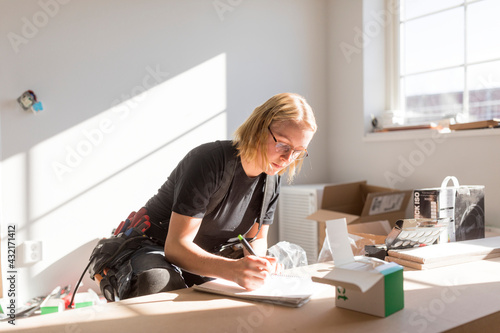 Woman drawing plan during house renovation photo