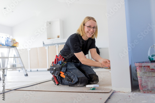 Female electrician renovating house photo