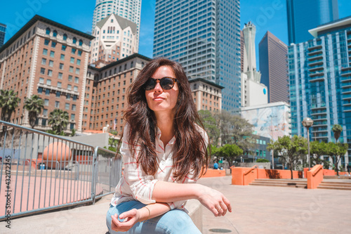 A young woman rests in a park in downtown Los Angeles