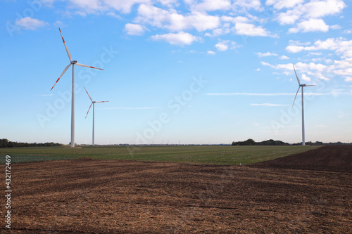 Wind turbine farms produce renewable energy in the field  color photo.