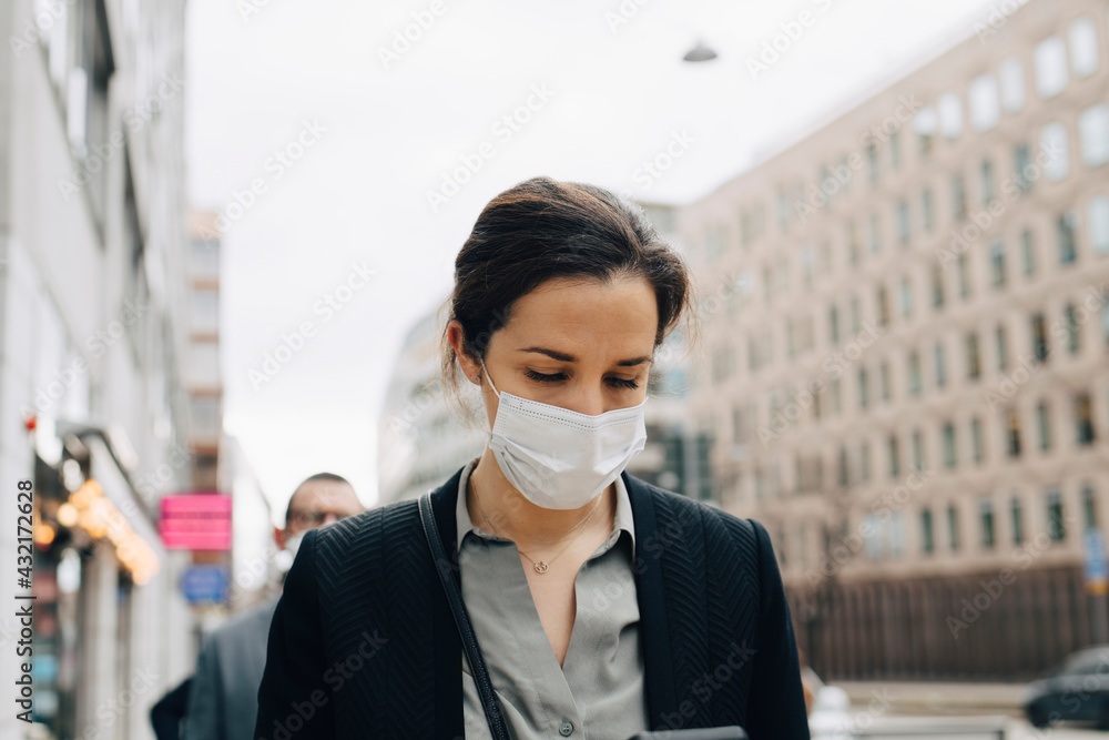 Female entrepreneur with protective face mask in city Female entrepreneur with protective face mask in city