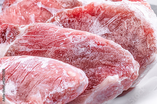 Obraz na płótnie Raw frozen meat pieces. raw pork chops close-up