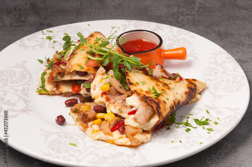 bright and juicy Mexican quesadilla with hot sauce
