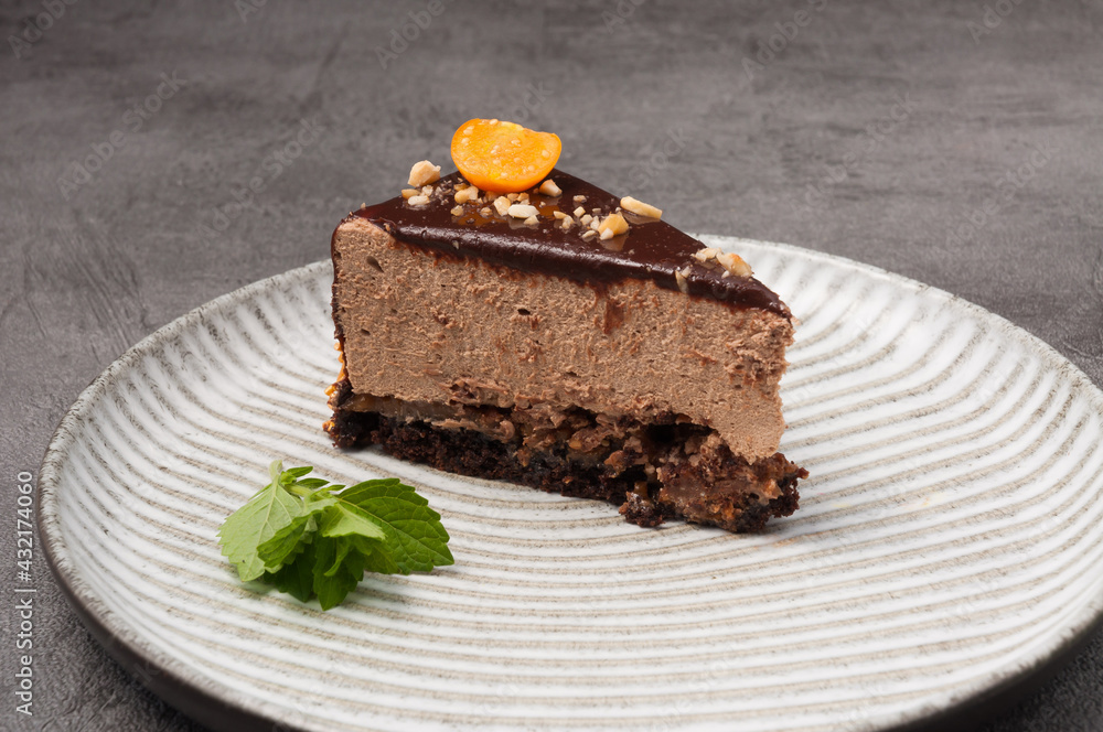 a piece of cake with chocolate mousse decorated with physalis and mint a piece of cake with chocolate mousse decorated with physalis and mint