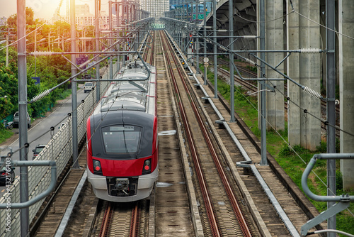 Electric train on the railway. Electric train  red-white  color  on railway in Bangkok, Thailand. New  Electric train in Bangkok, Thailand.