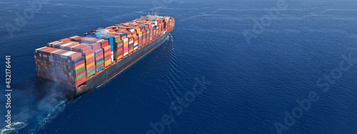 Fotografie Aerial drone ultra wide photo above huge colourful container carrier vessel crui