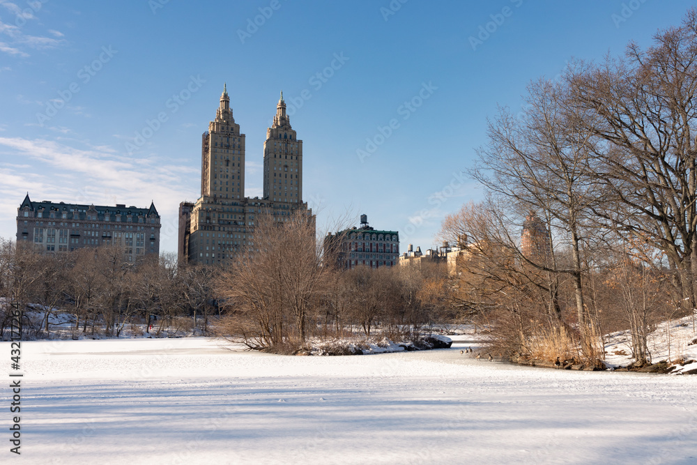 The Upper West Side Skyline seen from the Frozen Lake at Central Park with Snow in New York City 