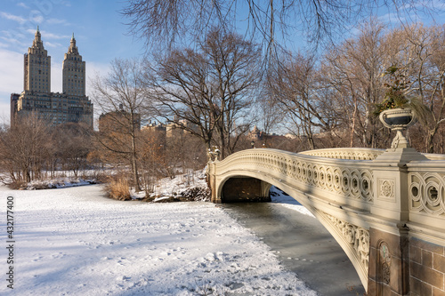 The Bow Bridge at Central Park with No People Over the Lake Covered with Snow in New York City © James