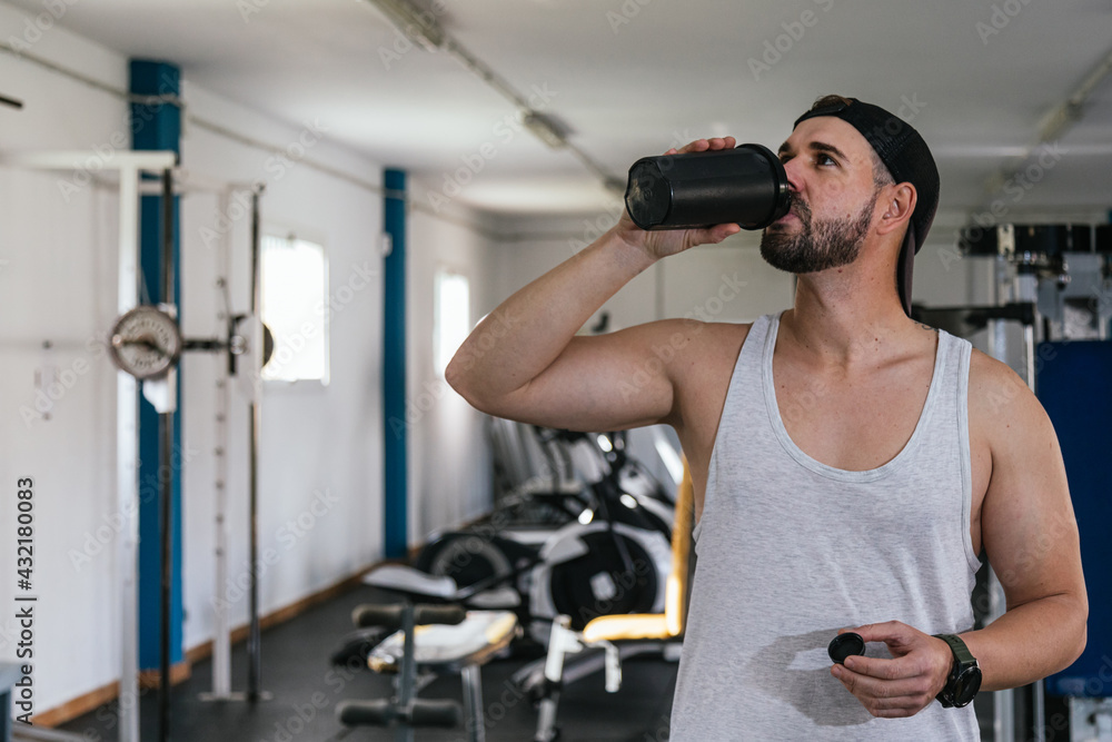 Male athlete drinking protein shake. Male athlete drinking protein shake.