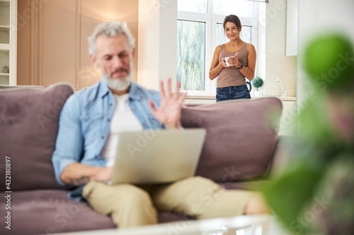 Attentive male person looking at scree of laptop