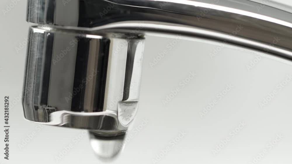 Water dripping from faucet tap at kitchen. Macro Water dripping from faucet tap at kitchen. Macro