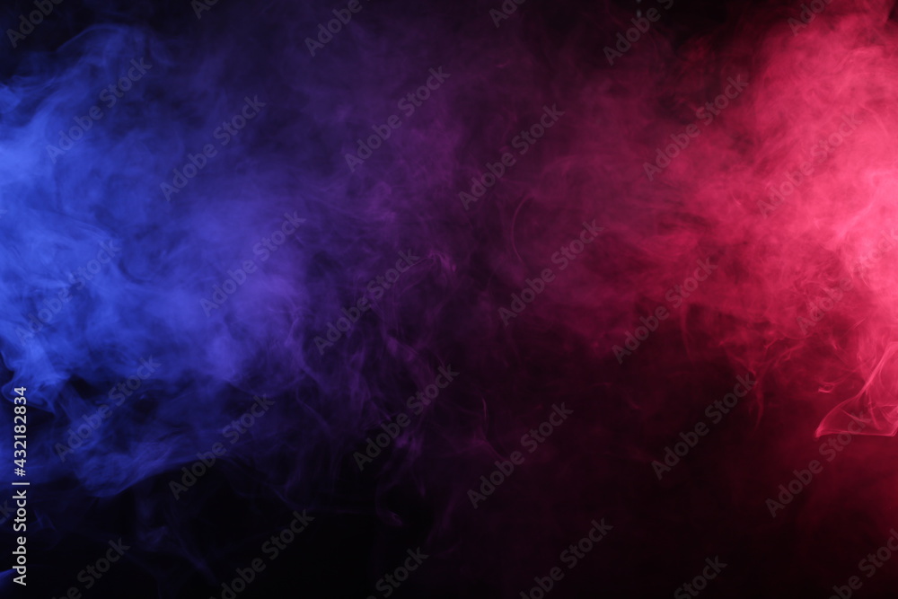 Artificial smoke in red-blue light on black background darkness