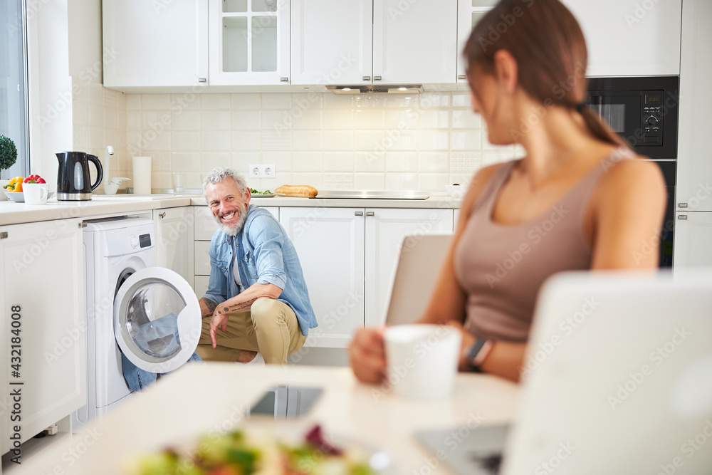 Joyful male person looking at his girlfriend