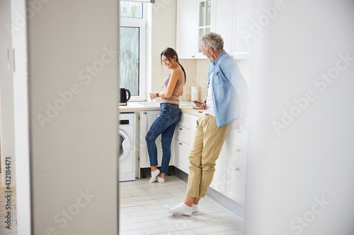 Sincere young woman standing in the kitchen