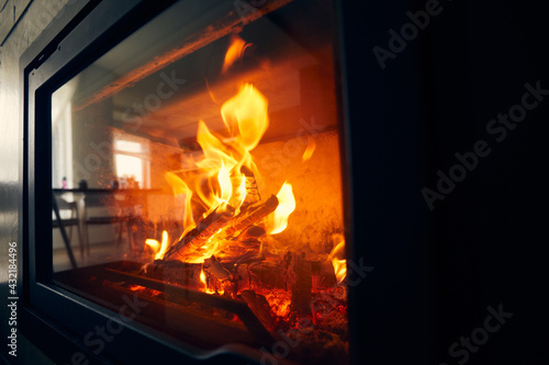 A fire burns in a fireplace  Fire to keep warm. Logs burning in a fireplace