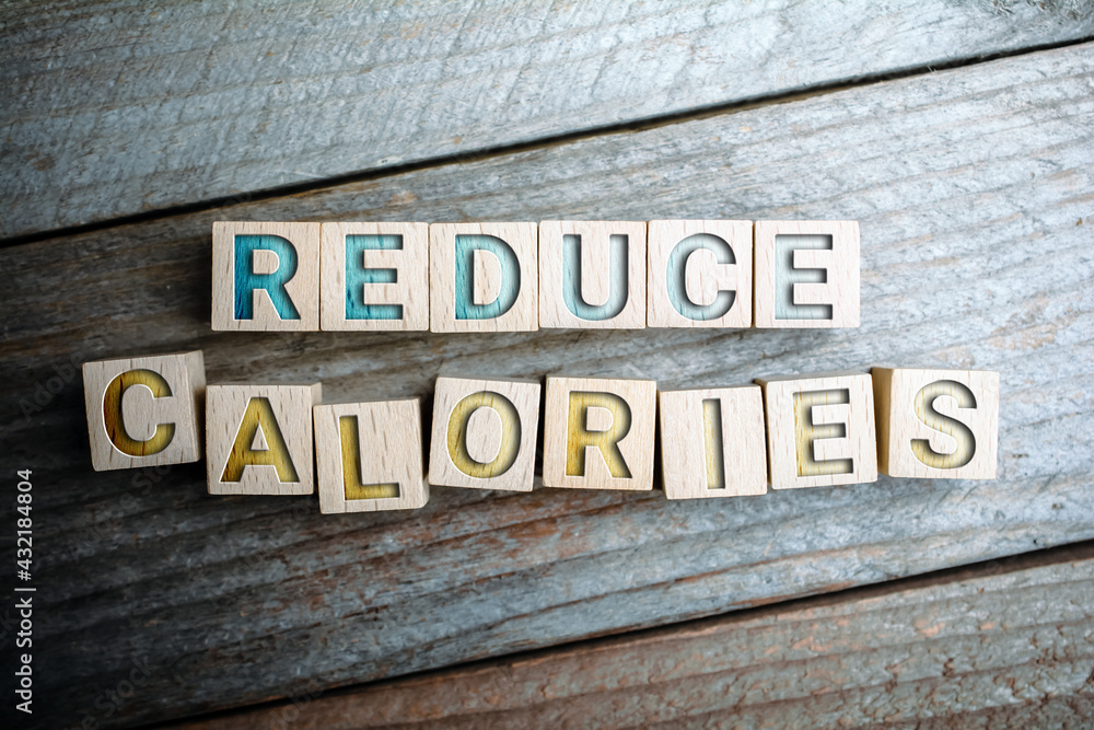 Reduce Calories Written On Wooden Blocks On A Board - Life Healthy Concept