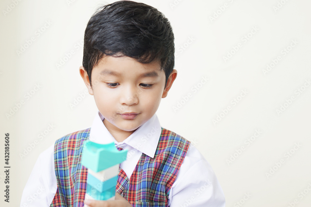 Cute Asian boy about 3 years old wearing a school uniform he has a happy face smile concept. Cute Asian boy about 3 years old wearing a school uniform he has a happy face smile concept.