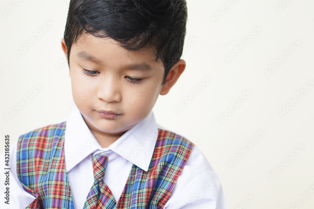 Cute Asian boy about 3 years old wearing a school uniform he has a happy face smile concept. Cute Asian boy about 3 years old wearing a school uniform he has a happy face smile concept.