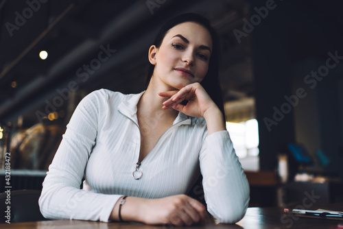 Thoughtful woman with hand at chin