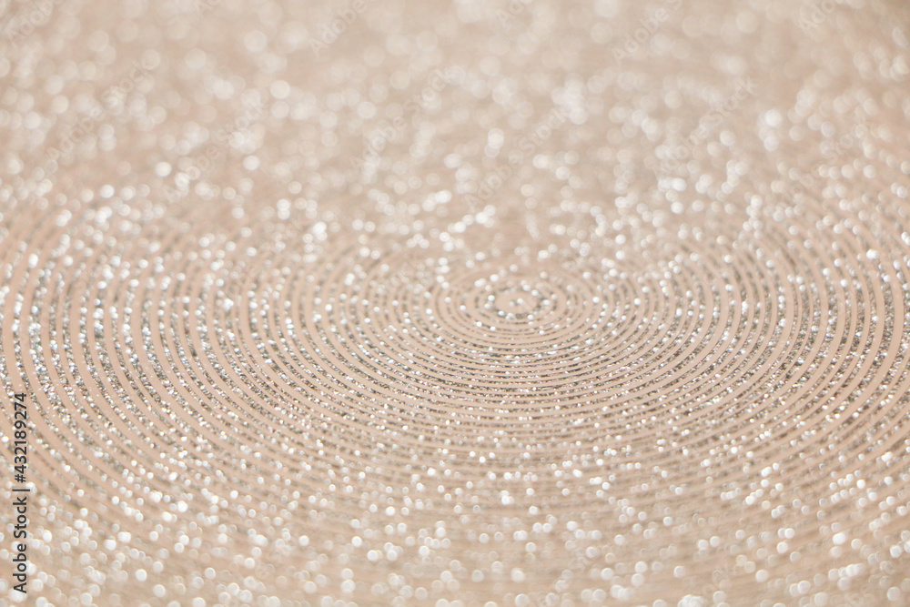 Fototapeta premium Abstract background of shiny rings of gray, black and beige colors with iridescent glitter.