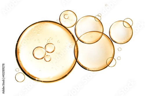 golden yellow bubble oil or serum isolated on white background photo