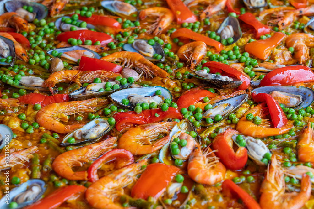 Spanish seafood paella in fry pan with mussels, shrimps and vegetables Spanish seafood paella in fry pan with mussels, shrimps and vegetables