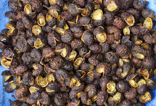 Macro full frame closeup of raw brown whole chinese sichuan timut pepper corns with citrus anise taste photo