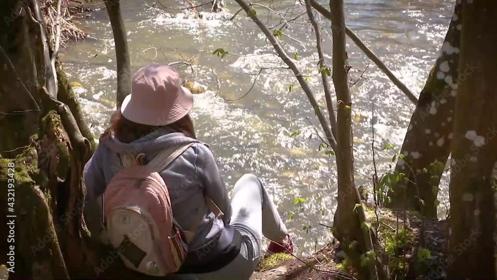 Teenage Girl In Sport Style Outfit Enjoying The Nature. A Girl In The Wood Resting By The River On Beautiful Sunny Day Teenage Girl In Sport Style Outfit Enjoying The Nature. A Girl In The Wood Resting By The River On Beautiful Sunny Day