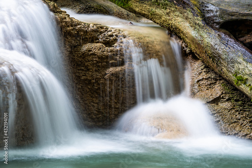 Fototapeta Naklejka Na Ścianę i Meble -  Waterfall and blue emerald water color in Erawan national park. Erawan Waterfall, Beautiful nature rock waterfall steps in tropical rainforest at Kanchanaburi province, Thailand