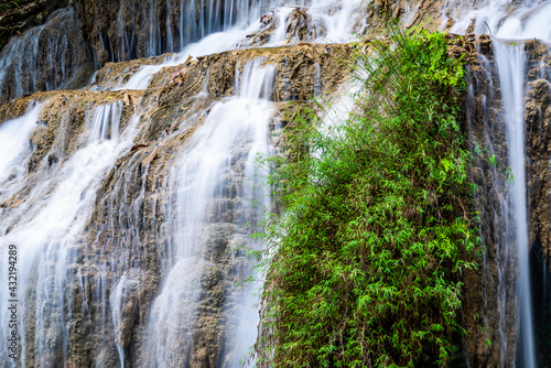 Waterfall and blue emerald water color in Erawan national park. Erawan Waterfall, Beautiful nature rock waterfall steps in tropical rainforest at Kanchanaburi province, Thailand