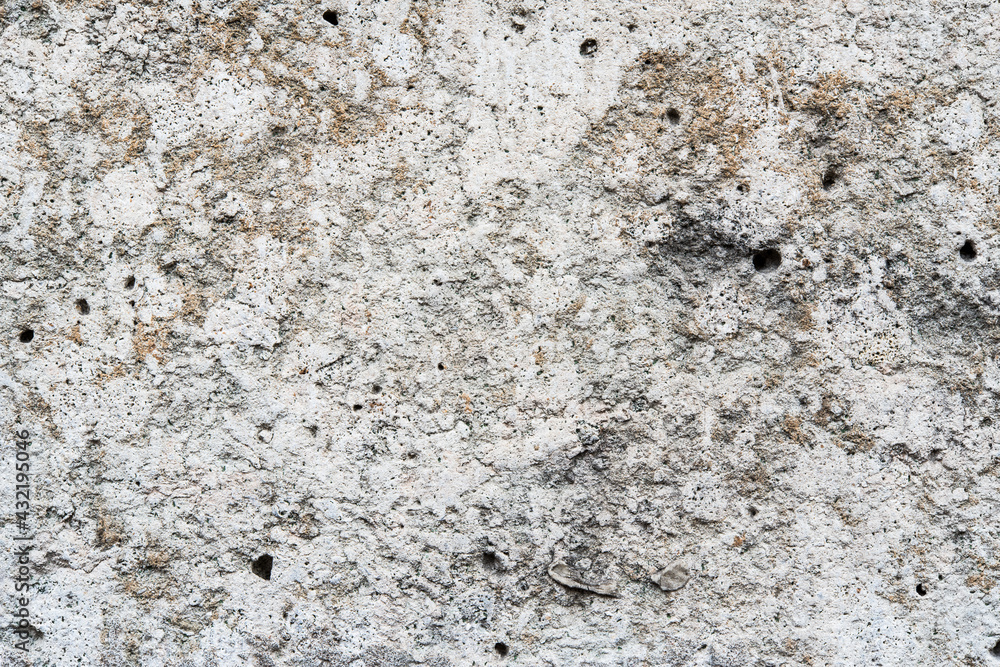 Old stone wall with holes. Close up view Old stone wall with holes. Close up view