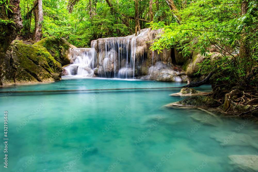 Waterfall and blue emerald water color in Erawan national park. Erawan Waterfall, Beautiful nature rock waterfall steps in tropical rainforest at Kanchanaburi province, Thailand Waterfall and blue emerald water color in Erawan national park. Erawan Waterfall, Beautiful nature rock waterfall steps in tropical rainforest at Kanchanaburi province, Thailand
