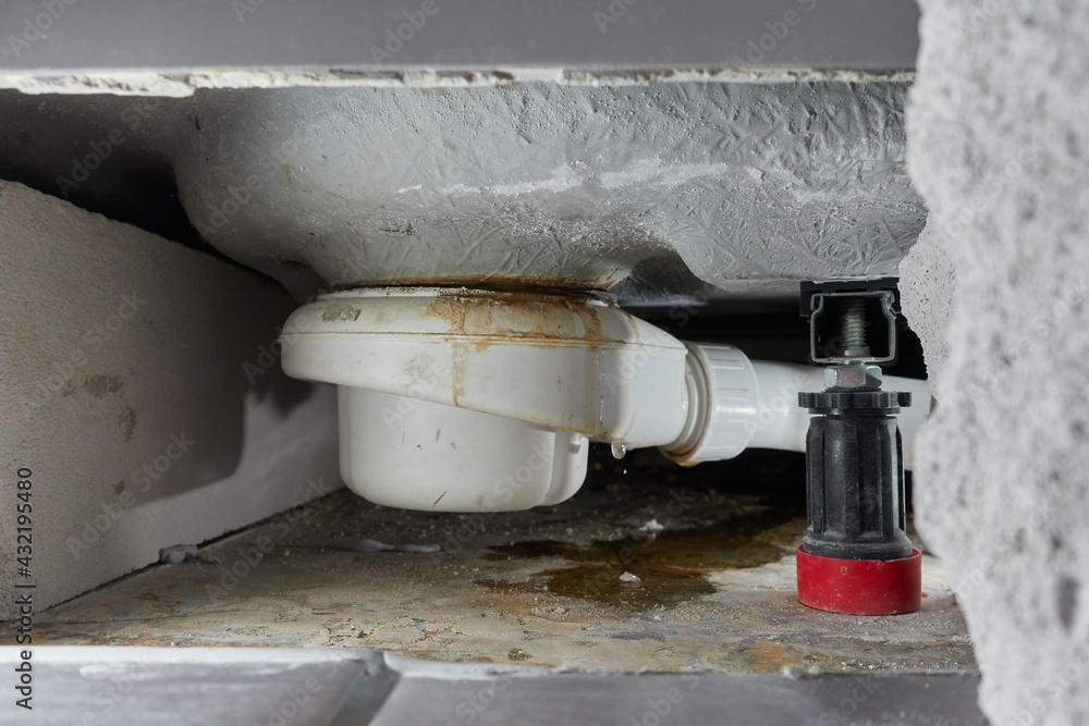 Leaking siphon of a shower tray in the bathroom, causes water damage